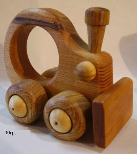 a wooden toy train with wheels and knobs