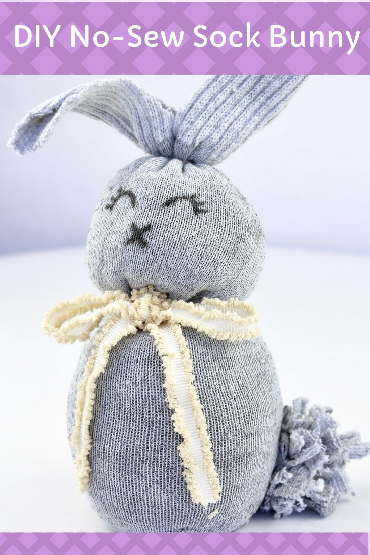 a gray stuffed animal sitting on top of a white table