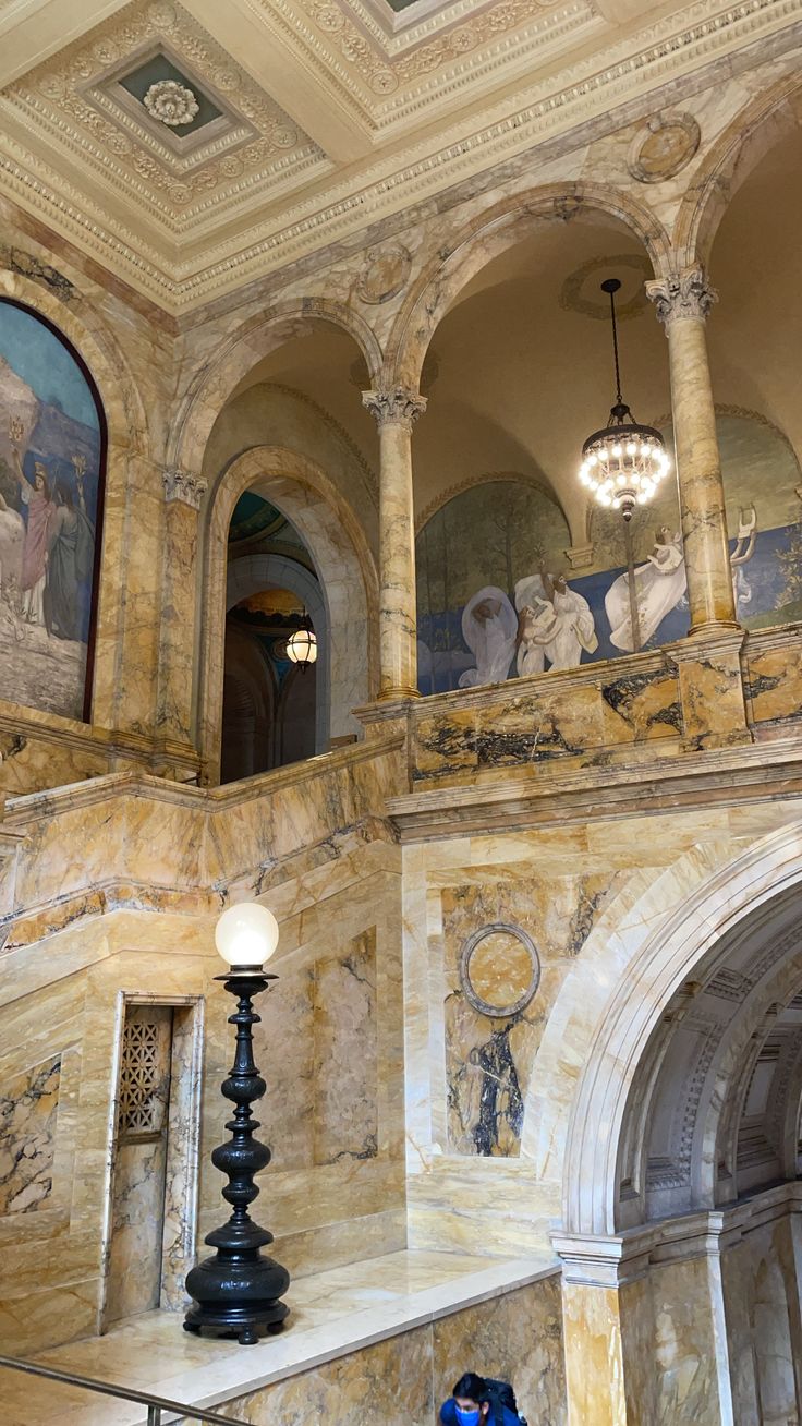 an ornately decorated building with paintings on the walls and ceiling, along with stairs