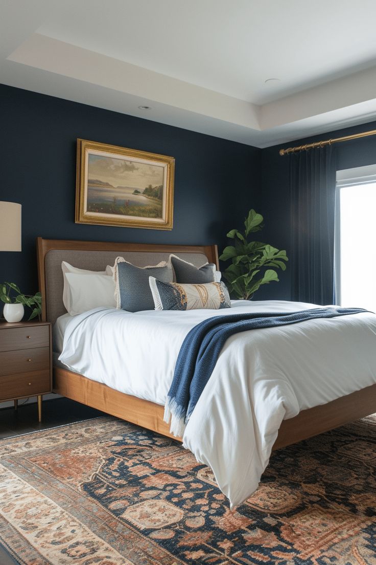 a large bed sitting next to a window in a bedroom on top of a rug