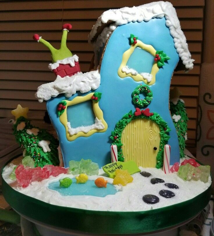 there is a cake that looks like a house with decorations on the front and sides