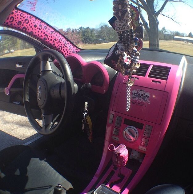 the interior of a pink car is decorated with beads and leopard print, as well as other accessories