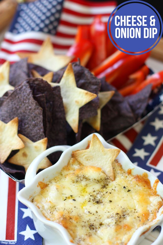 cheese and onion dip in a bowl surrounded by tortilla chips on an american flag plate