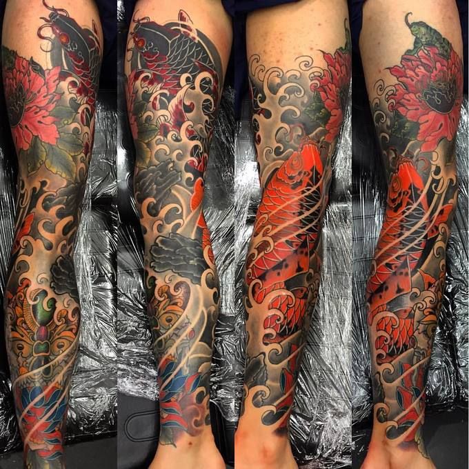 the legs are covered with tattoos and designs