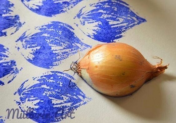 an onion sitting on top of a piece of paper with blue ink drawn on it