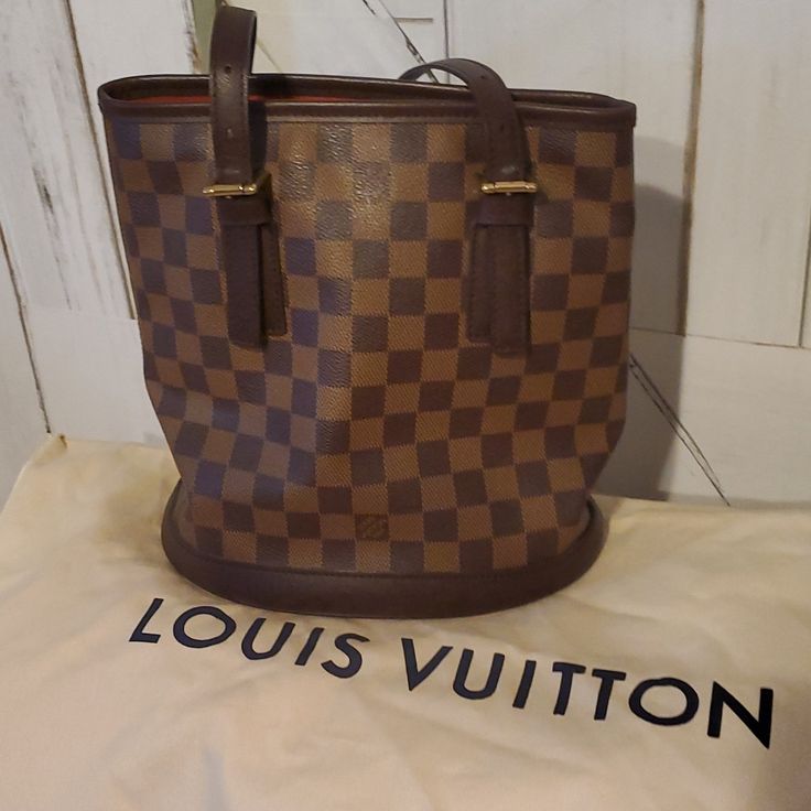 Reposhing This Item I Purchased From @Exalbinski2018. Excellent Condition, Loved It, But Ready To Rotate For Something New. It Has Been Verified As Being Authentic. Questions? Leave A Comment Below! Luxury Pre-owned Brown Bag, Modern Brown Monogram Canvas Bucket Bag, Pre-owned Designer Brown Bags, Designer Brown Bucket Bag For Travel, Designer Brown Bucket Bag, Formal Brown Monogram Canvas Bucket Bag, Designer Brown Bucket Bag For Formal Occasions, Designer Formal Brown Bucket Bag, Elegant Brown Monogram Canvas Bucket Bag