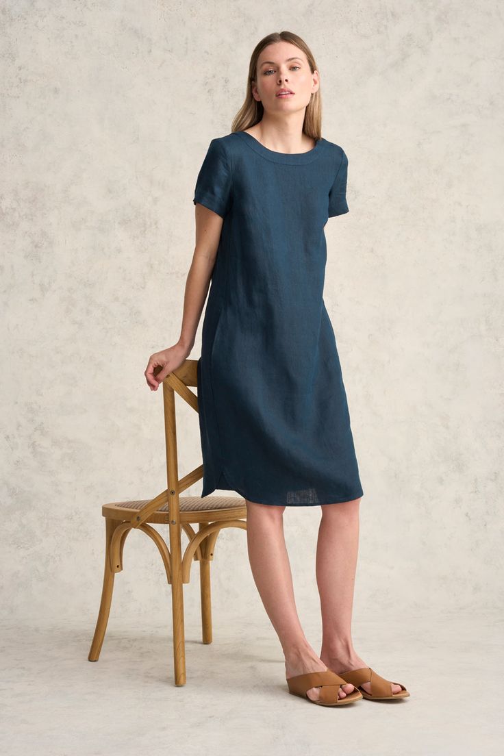 Perfect for transeasonal weather, this 100% French linen shift dress features a relaxed fit through the body with trendy side pockets and a curved hem. Available in Ink with a scoop neck, this flattering and comfortable style can be paired back with a white sneaker for a classic casual look. Spring Crew Neck Dress With Side Pockets, Summer Crew Neck Dresses With Side Pockets, Summer Dresses With Crew Neck And Side Pockets, Summer Dresses With Side Pockets And Crew Neck, Casual Crew Neck Dress With Side Pockets, Casual Knee-length Shift Linen Dress, Casual Knee-length Linen Shift Dress, Casual Linen Dress With Pockets And Relaxed Fit, Casual Blue Linen Dress For Work