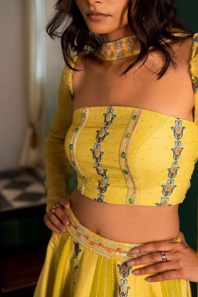 Yellow panelled lehenga with bead, cutdana and pearl embroidery and attached cancan. Paired with a padded embroidered bustier and choker style dupatta.
Components: 3
Pattern: Embroidered
Type Of Work: Bead, Cutdana, Pearl
Neckline: Straight
Sleeve Type: Long
Fabric: Muslin
Color: Yellow
Other Details: 
Attached lining
Closure:
Lehenga: Button
Occasion: Mehendi and Haldi - Aza Fashions Panelled Lehenga, Embroidered Bustier, Pearl Embroidery, Types Of Work, Choker Style, Set Women, Set For Women, Aza Fashion, Sleeve Type