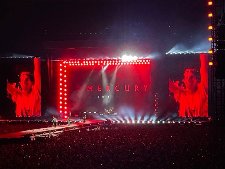 the stage is lit up with red and white lights