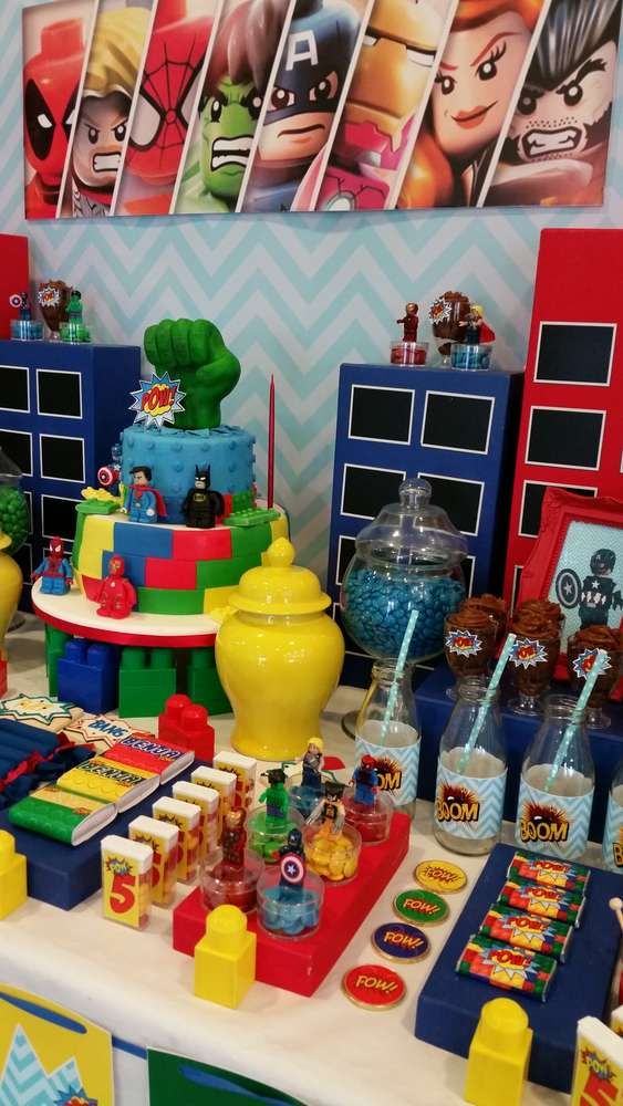 the table is full of legos and toys for children's birthday party decorations