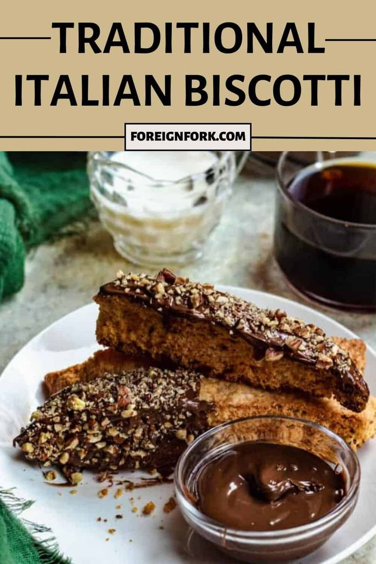 two pieces of bread on a white plate with chocolate sauce in front of it and the words traditional italian biscotti