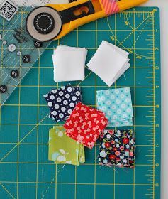 sewing supplies laid out on top of a cutting board with scissors and fabric scraps