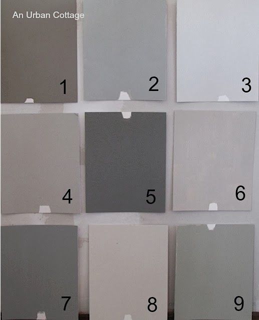 several different shades of gray and white paint on the wall with numbers in each section