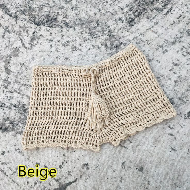 a close up of a piece of cloth on a stone surface with the word beige written below it