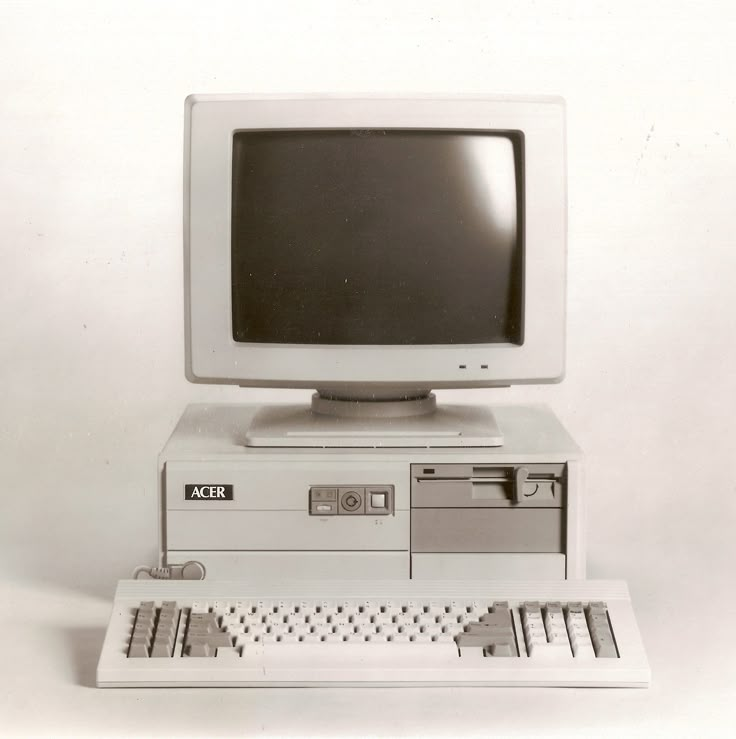 an old computer sitting on top of a desk with a keyboard and mouse in front of it