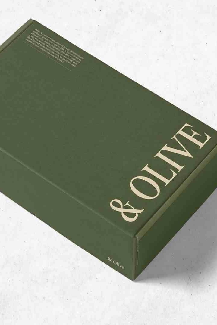 a green book with gold lettering sitting on top of a white surface