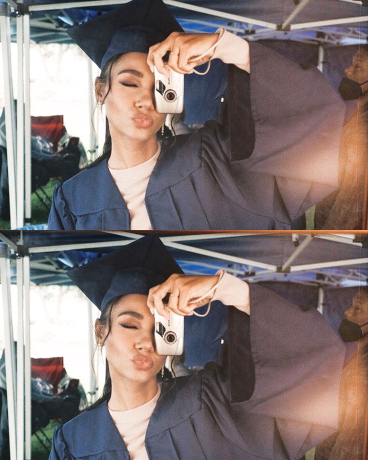 a woman in graduation cap and gown holding a camera