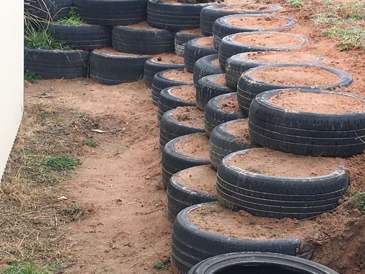 a bunch of tires that are sitting in the dirt