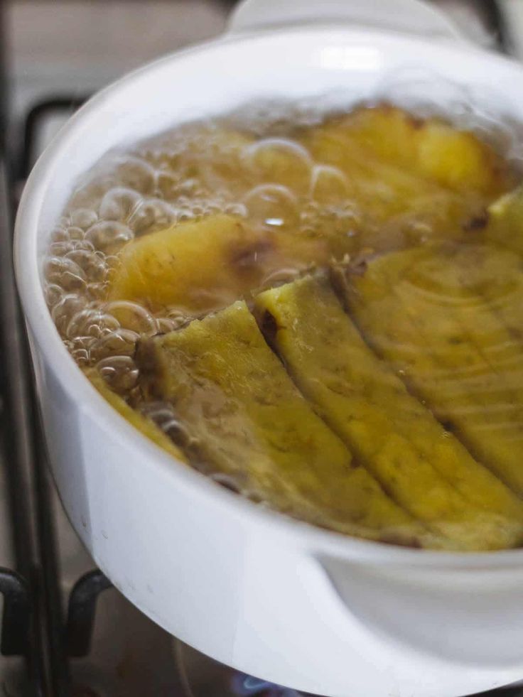 a white bowl filled with food on top of a stove