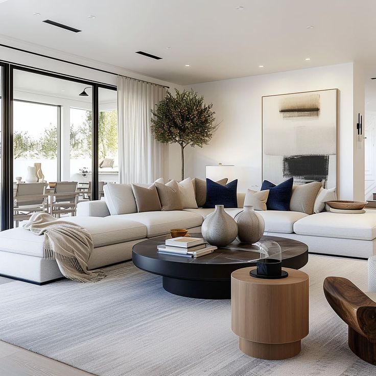 a living room filled with white furniture and lots of pillows on top of it's couches