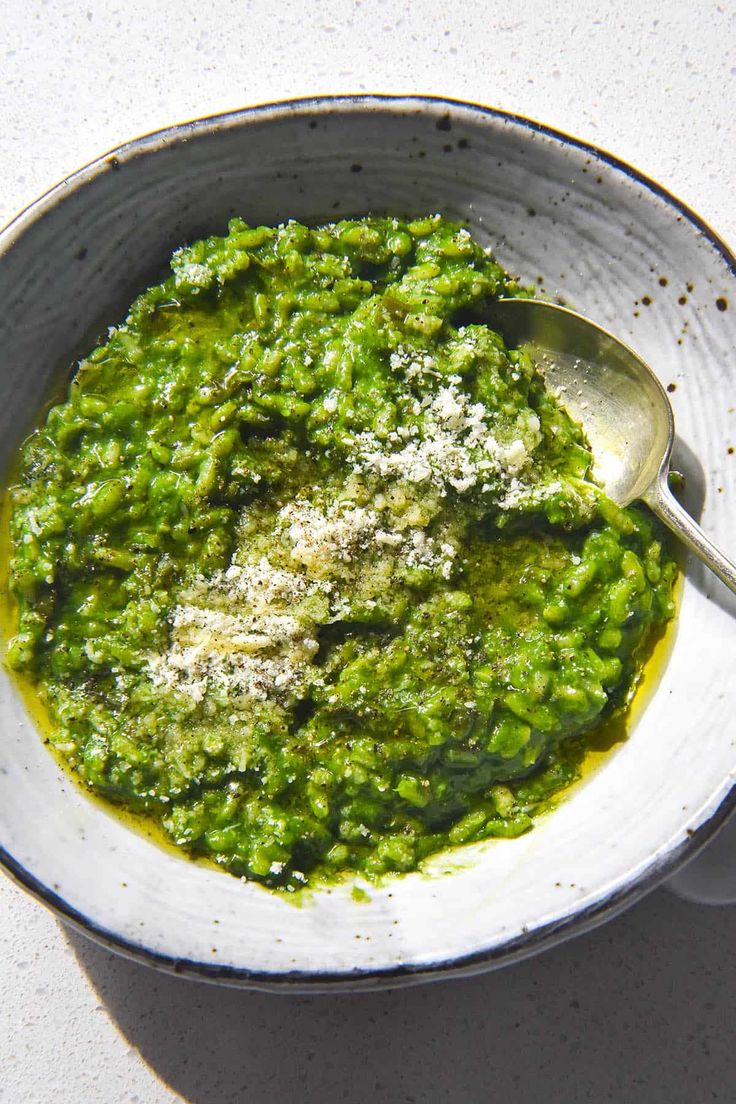 a white bowl filled with green pesto