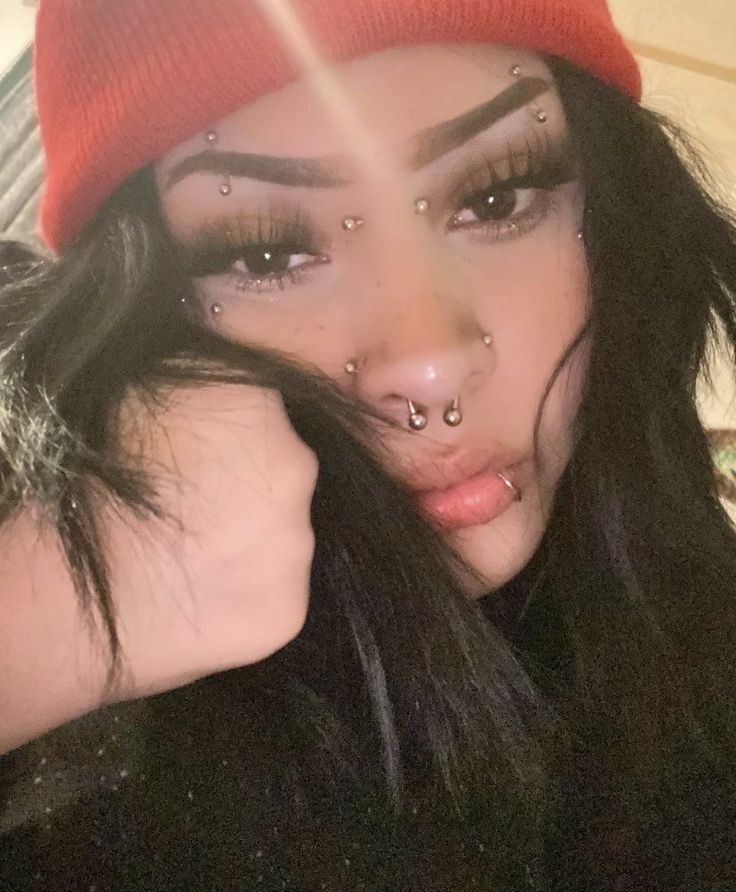 a woman with piercings on her nose and nose is posing for a selfie