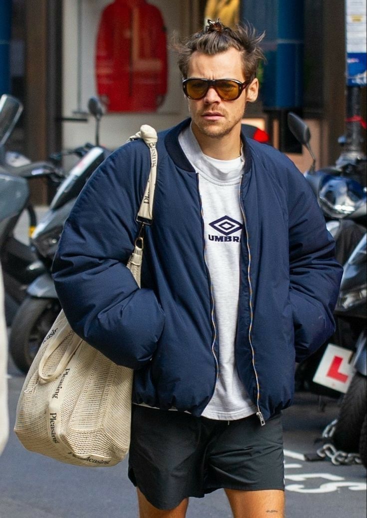 a man walking down the street in shorts