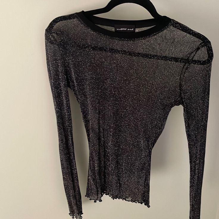 Black Shear Top Never Worn. Doesn’t Have Original Tags. Has Stretch. Lettuce Cut Hem With Glitter. Stretch Long Sleeve Mesh Top With Sequins, Long Sleeve Stretch Mesh Top With Sequins, Stretch Long Sleeve Sequin Mesh Top, Stretch Long Sleeve Mesh Top For Party Season, Black Sequined Mesh Top For Party, Glamorous Long Sleeve Mesh Top For Party Season, Glitter Crew Neck Tops For Night Out, Black Mesh Top With Sequins For Evening, Black Mesh Top With Sequins For Night Out