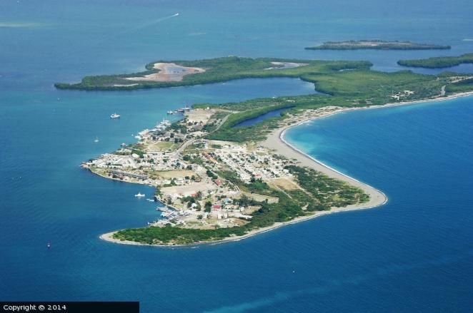 an island in the middle of blue water