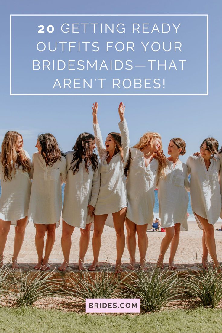 bridesmaids in white robes standing on the beach with text overlay reading 20 getting ready outfits for your bridesmaids - that aren't robes