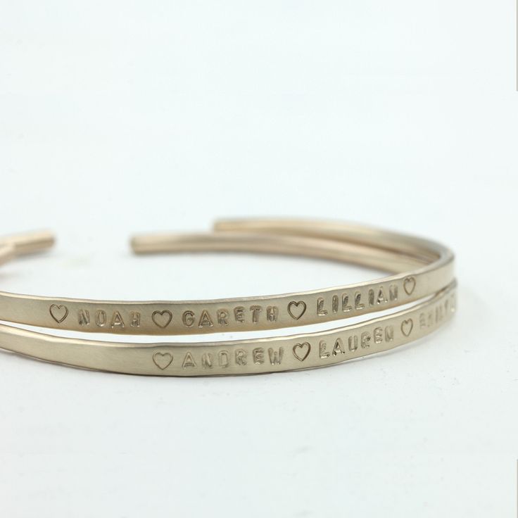 "Personalized solid gold cuff bracelet. Available in 14k or 18k yellow gold, rose gold or white gold. Personalized with a hand stamped engraved inscription or left bank. The inscription is not darkened in unless specifically requested. I hand hammer each one so there is some variation to each one and there is a sight textured on the edges which gives them an organic and rustic look to them. Wear one at a time or stack them all up. To figure out your sizing measure the circumference of your wrist Gold Hand Stamped Bracelets For Anniversary, Hand Stamped Gold Bracelets For Anniversary, Elegant Stamped Bangle As Gift, 14k Gold Jewelry With Engraved Text, Elegant Stamped Gold Bracelets, 14k Rose Gold Cuff Bracelet For Anniversary, Modern Engraved 14k Gold Bracelets, Elegant Stamped Bangle Perfect For Gifts, Minimalist Stamped Bracelets For Anniversary