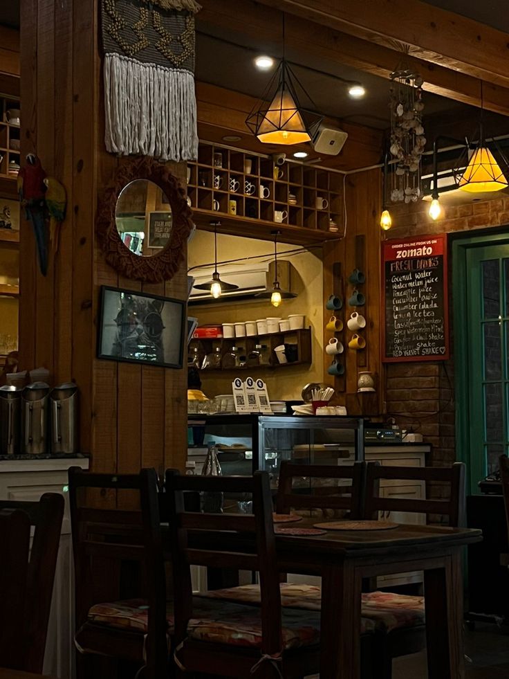 the inside of a restaurant with wooden tables and chairs