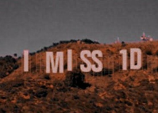 a sign that reads i miss you on top of a hill