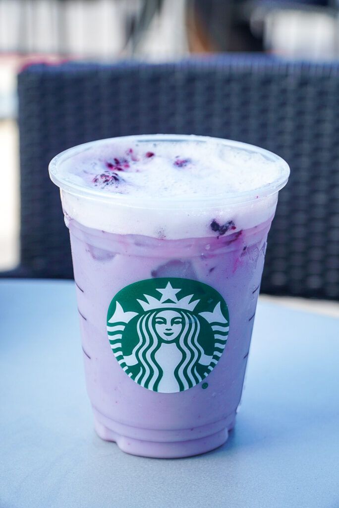 a purple drink sitting on top of a table