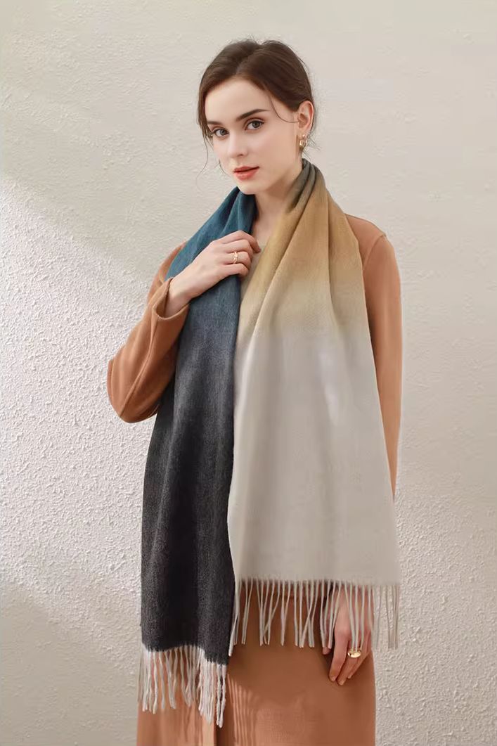 Ombre Elegance in 100% Wool Elevate your winter fashion with our Ombre 100% Wool Fringe Scarf. Crafted from 100% wool, it provides a soft, cozy feel while ensuring you stay warm. The beautiful ombre design seamlessly transitions from one color to the next, making it a fashionable statement piece. The finely crafted edges and fringe add a chic touch. Style #: WKAI511 Warm Wool Scarves For Fall, Warm Wool Scarf For Fall, Gray Wool Scarf For Fall, Beige Wool Scarves For Winter, Elegant Gray Scarves For Fall, Elegant Scarves For Cold Weather In Fall, Elegant Scarves For Cold Weather And Fall, Elegant Fall Scarves For Cold Weather, Elegant Winter Scarves For Cold Weather