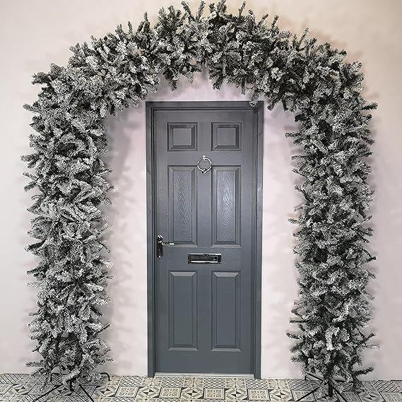 a door is decorated with silver christmas trees