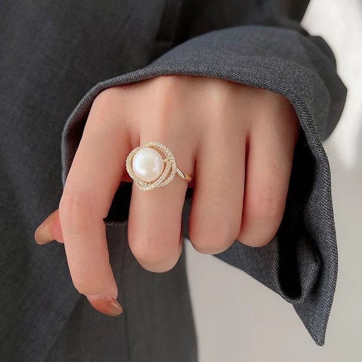 Live your vintage inspired dreams with our pearl and diamond ring. With the pearl bead in the middle and CZ Diamonds surrounding this is the perfect romantic gift for an engagement ring.• Material: High Quality 14K Gold Plated• Finish: 14K Gold Pearl Finger Ring, Big Pearl Ring, Middle Finger Ring, Precious Stones Rings, Pearl Engagement Ring, Pendant Ring, Unusual Rings, Pearl Necklace Earrings, Pearl And Diamond Ring