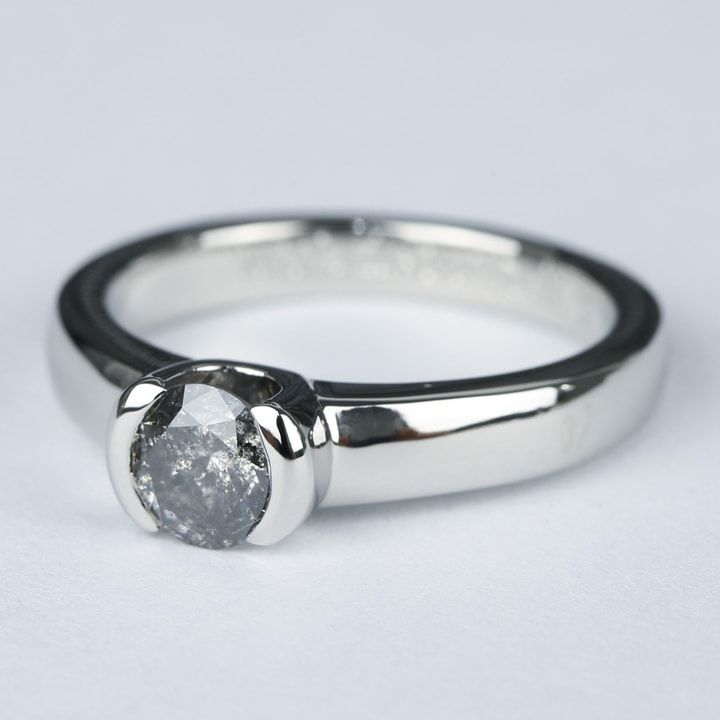 a close up of a diamond ring on a white background