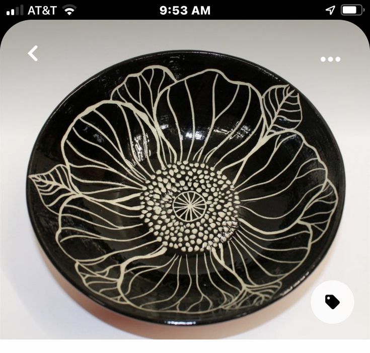 a black bowl with white designs on it