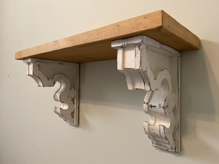 two wooden brackets are attached to the wall