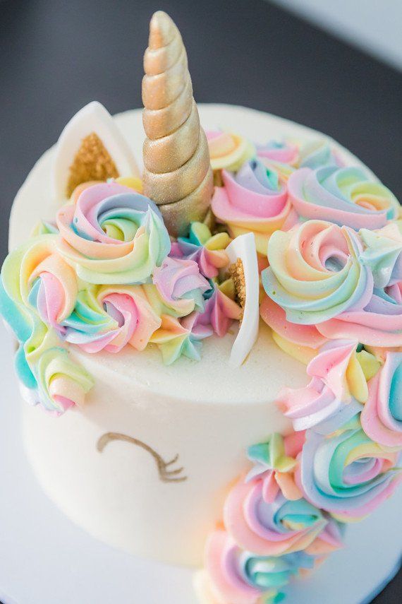 there is a cake decorated like a unicorn