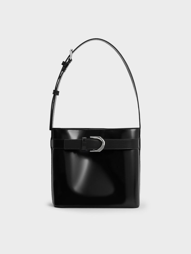 The Gabine collection is expanded with a brand new silhouette -- a sleek and slouchy bucket style. Made with black calf leather, this bag promises excellent style mileage and versatility. It will complement a wide range of styles, from casual to edgy. Fitted with a magnetic closure, it also offers easy access to your belongings. The thick shoulder strap ensures carrying comfort, and can be easily adjusted to your preferred length. Cheap Black Square Bucket Bag, Black Leather Bucket Bags, Luxury Black Pebbled Leather Bucket Bag, Designer Business Bucket Shoulder Bag, Designer Bucket Shoulder Bag For Business, Chic Leather Bucket Bag For Business, Designer Bucket Hobo Bag For Evening, Designer Evening Bucket Hobo Bag, Elegant Evening Bucket Bag With Silver-tone Hardware