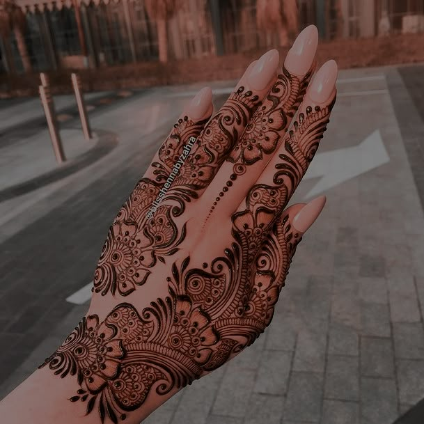 a woman's hand with henna on it