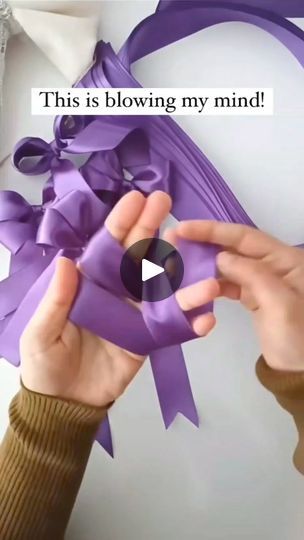 a person holding a purple bow with the words, this is blowing my mind