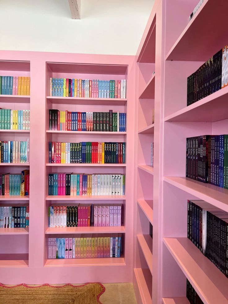 a pink book shelf filled with lots of books