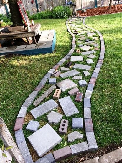 a garden path made out of bricks and stones