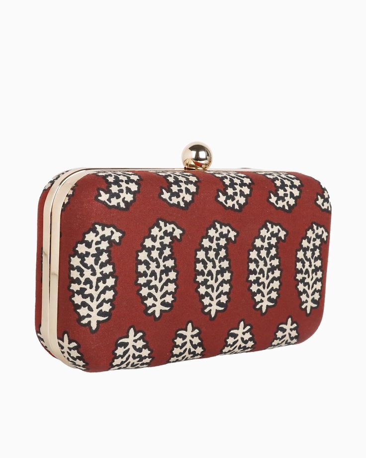 Carry our Foglia clutch bag with beautiful paisley pattern. This clutch evening bag is a stylish way to step into the night. The gold metal frame and push lock closure give it a touch of glamor, while the sling chain strap means you can wear it however you want - in hand, over the shoulder or across the body. The block printed fabric adds a hint of vibrant charm, and though small in size, it fits an iPhone and essentials for an evening out. Whether you're headed to a wedding or a night on the to Traditional Rectangular Coin Purse For Evening, Red Pouch Box Bag For Formal Occasions, Elegant Red Pouch Box Bag, Red Formal Shoulder Bag Rectangular Case, Red Formal Pouch Box Bag, Evening Rectangular Box Bag, Red Rectangular Festive Clutch, Red Evening Shoulder Bag, Festive Red Rectangular Clutch