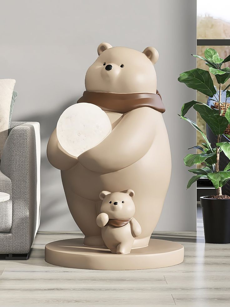 there is a statue of a bear holding a baby bear