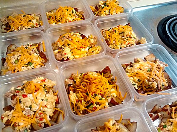 several plastic containers filled with food on top of a stove