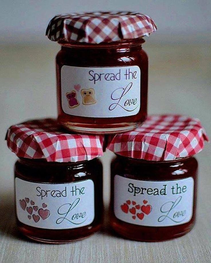 four jars of spread the love jam on a table